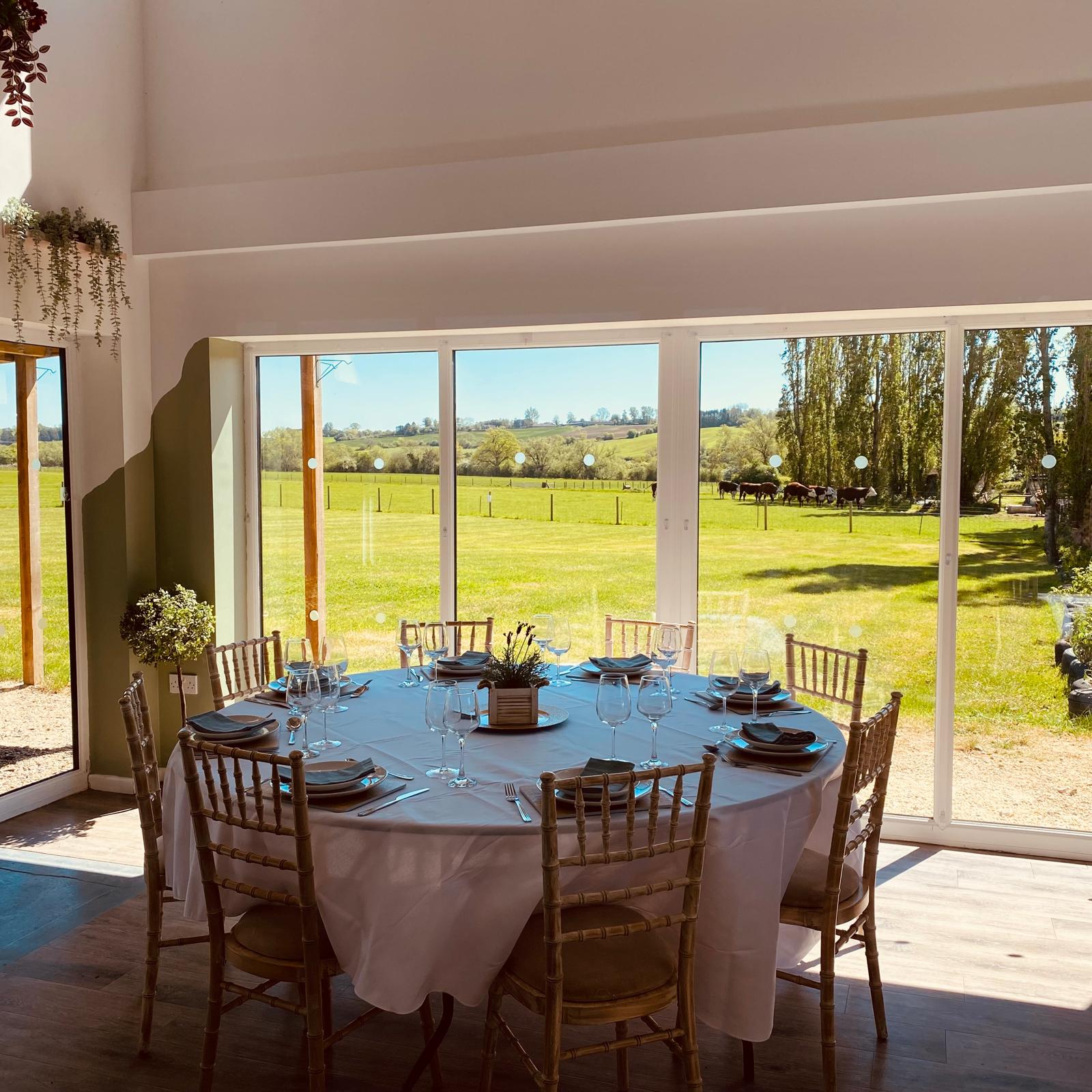Table set beside large windows overlooking fields
