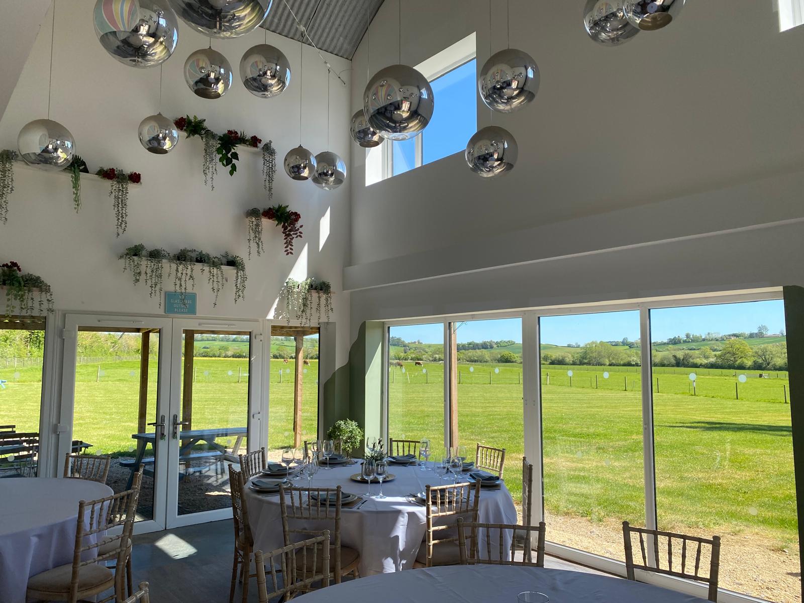 High ceiling barn interior with countryside views
